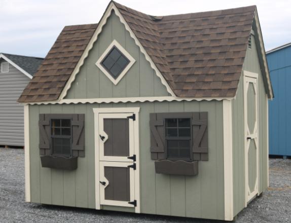 Pine Creek 8x10 Victorian Playhouse with PC Green walls, Navajo White trim and Bronze Z-Style shutters, and Barkwood shingles